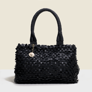 Woven leather bag. in black with solid handle. 
